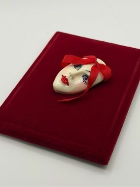 Vintage Face Brooch with Red Ribbon Accent